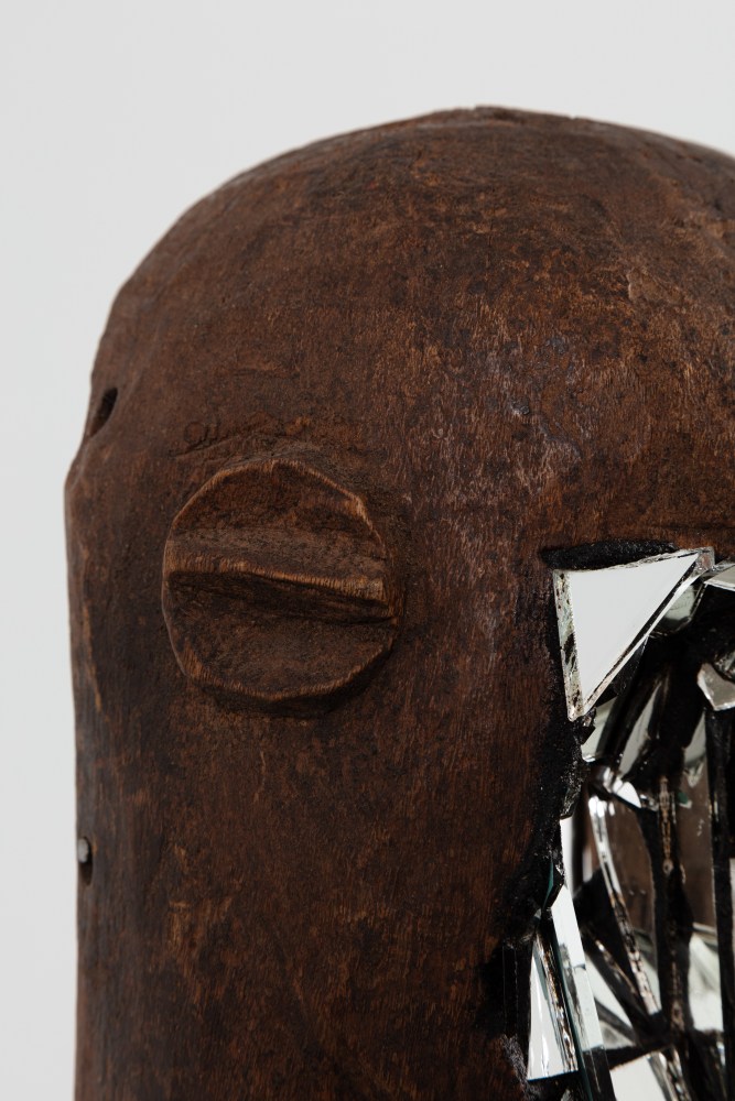 Kader Attia
Mirror Mask&amp;nbsp;(detail)
2020
Wooden mask, mirror fragments, black pigment
Artwork Dimensions:
11 3/4 x 6 5/8 x 5 1/2 inches (30 x 17 x 14 cm)
Overall Dimensions:
70 x 10 x 10 inches (177.8 x 25.4 x 25.4 cm)