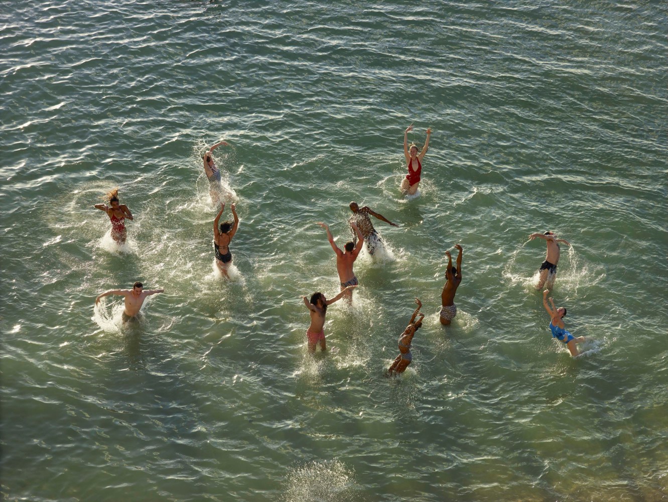 a group of joyful dancers in the ocean
