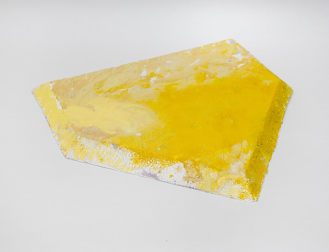 a yellow sculpture in the shape of a baseball plate