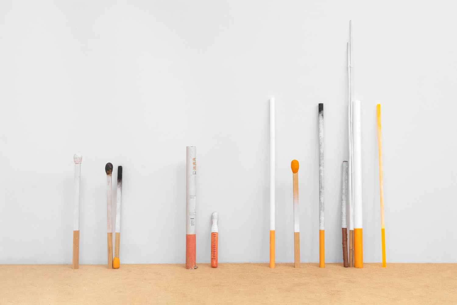 Encubrimiento estad&amp;iacute;stico, 2021
Wood, acrylic, tobacco, paper, PET, sponge, cardboard, found objects, mixed media on orange carpet (35 elements)
Installed: 200 x 717.5 x 30 cm