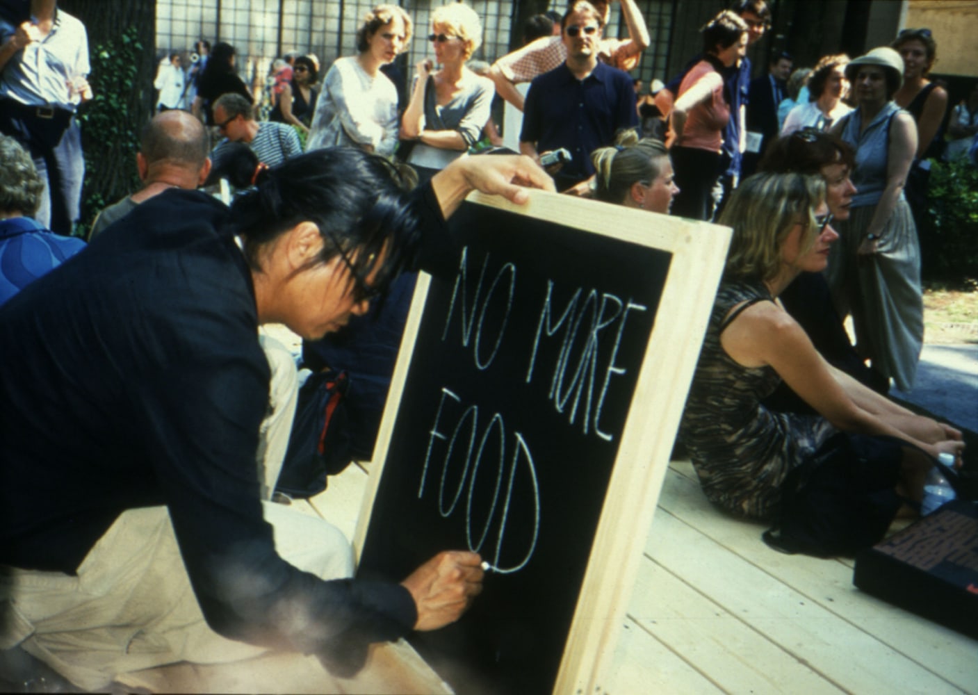 untitled 1999 (royal thai pavilion), 1999
wooden platform, teak tree, chalkboard, chalk, posters, advertisements, envelopes, invitation cards, flags, performance schedule

variable dimensions