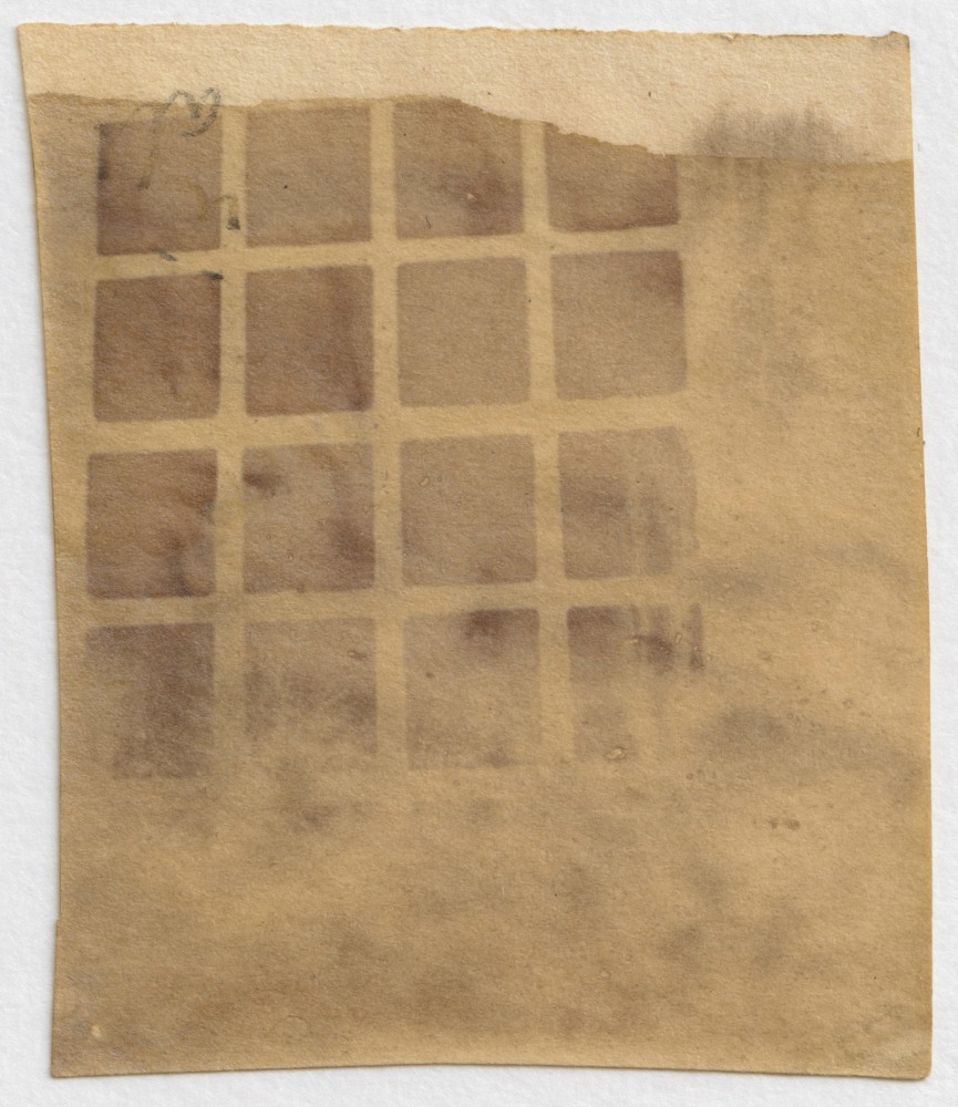 William Henry Fox TALBOT (English, 1800-1877) Lacock woodyard through lattice window, circa 1839-1840 Photogenic drawing mousetrap camera negative 4.3 x 3.6 cm