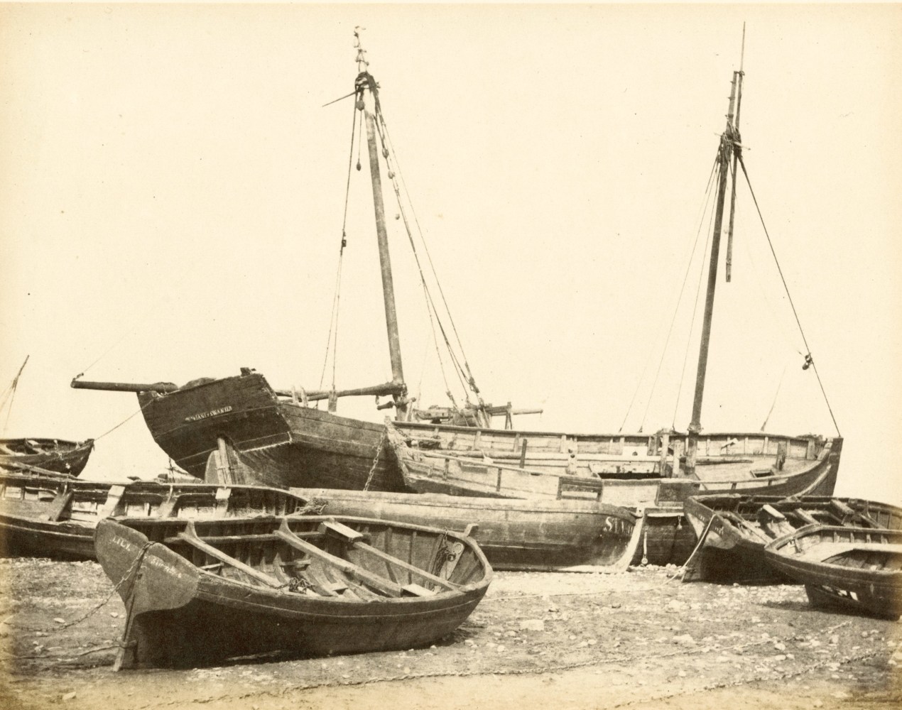 Hugh Owen&amp;nbsp;(English, 1808-1897)
Oyster boats, Swansea
Albumen print, 1860s-1870s, from a paper negative, before 1855
17.3 x 22.2 cm mounted on 26.0 x 28.3 cm album sheet
Numbered &amp;quot;60&amp;quot; in pencil on mount

By the mid 1850s when the glass wet collodion negative dominated British commercial photography, Hugh Owen remained loyal to Talbot&amp;#39;s calotype negative process on paper. Owen&amp;#39;s calotypes in the 1851 Great Exhibition so impressed the Commissioners that they hired him to record displays in the Crystal Palace. The following year, Owen became a member of the Founding Council of the Photographic Society and contributed regularly to their exhibitions. The oyster boats are beached by the low tide typical of Swansea&amp;#39;s extreme tidal swing during the heyday of oyster fishing.