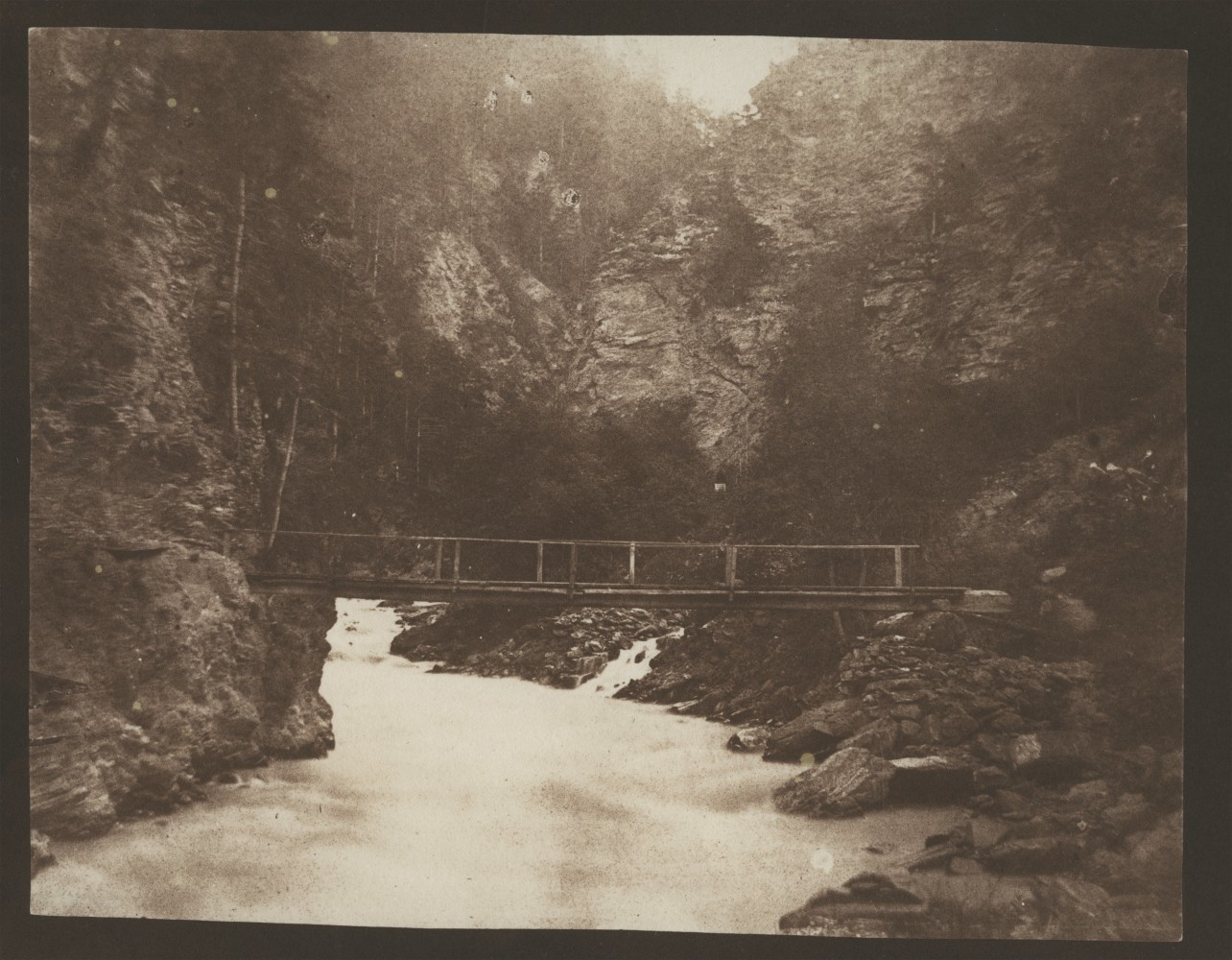 William Henry Fox TALBOT (English, 1800-1877) Rustic bridge across a gorge, probably in Scotland, circa 1844 Salt print from a calotype negative 14.1 x 18.1 cm on 19.7 x 24.1 cm paperWilliam Henry Fox TALBOT (English, 1800-1877) Rustic bridge across a gorge, probably in Scotland, circa 1844 Salt print from a calotype negative 14.1 x 18.1 cm on 19.7 x 24.1 cm paper