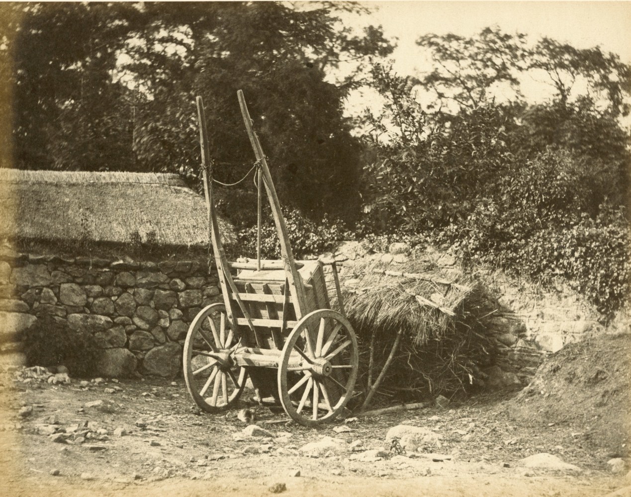 Hugh OWEN (English, 1808-1897) Cart and thatched kindling storehouse Albumen print, 1860s-1870s, from a paper negative, before 1855 17.6 x 22.5 cm mounted on 26.0 x 28.3 cm album sheet Numbered &quot;36&quot; in pencil on mount