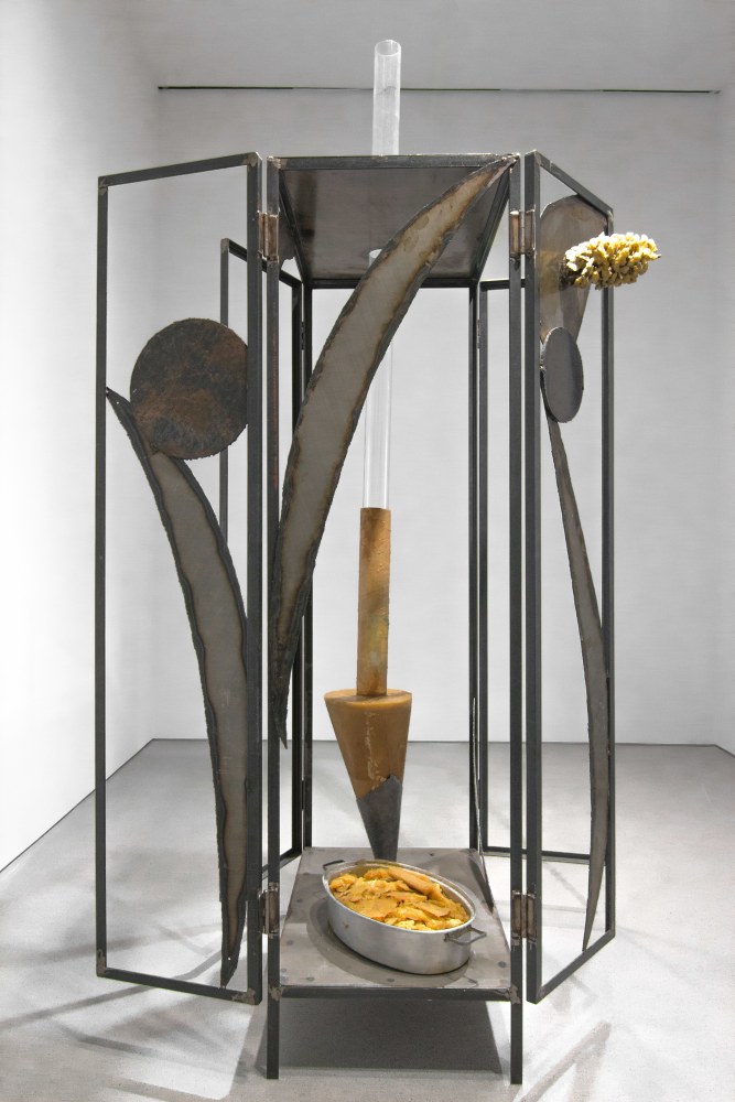 sculpture made of a large metal frame with wax elements attached