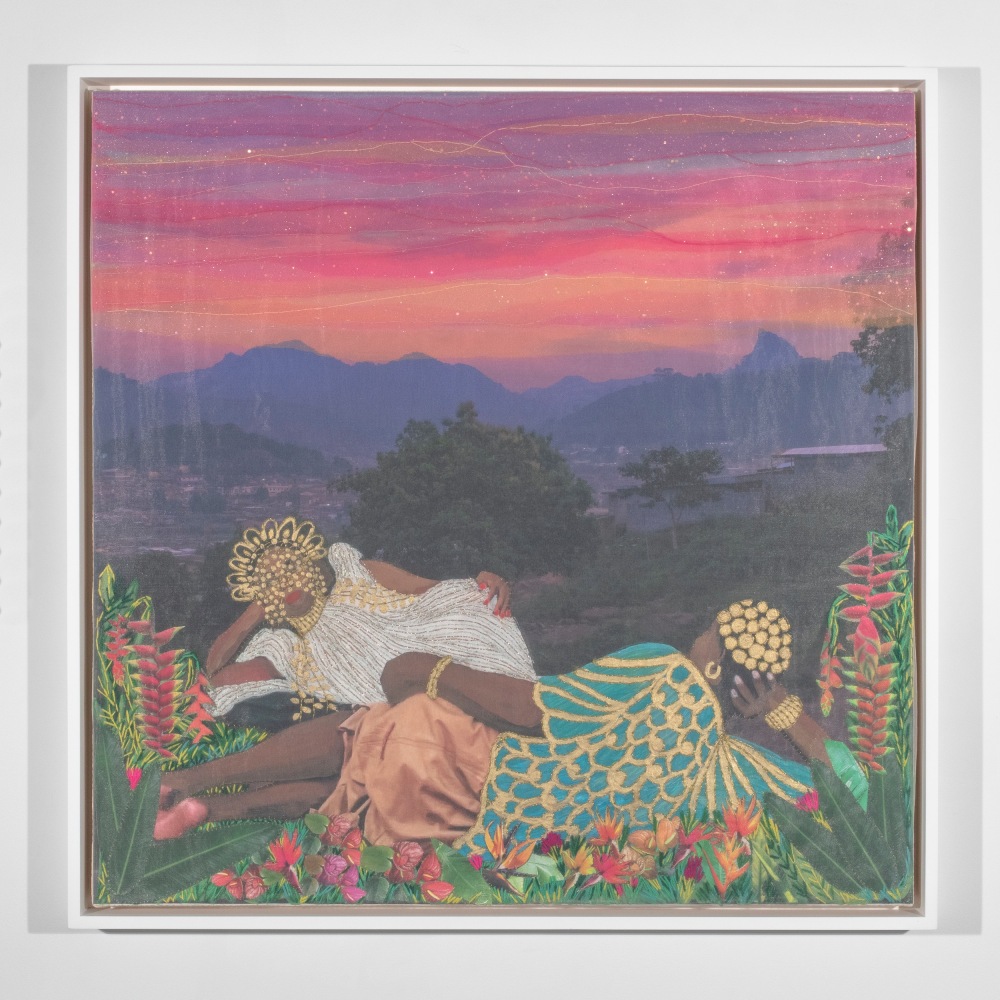 Two women with gold headwear reclining in garden with trees and city in distance against sunset backdrop