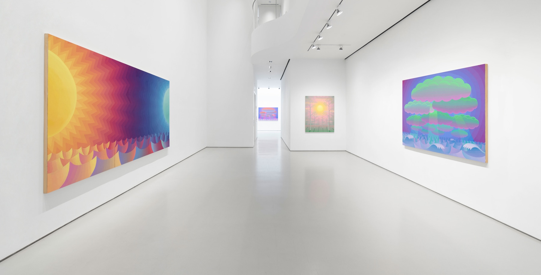 View of gallery with brightly colored landscape and seascape paintings in yellows, pinks, blues, and greens
