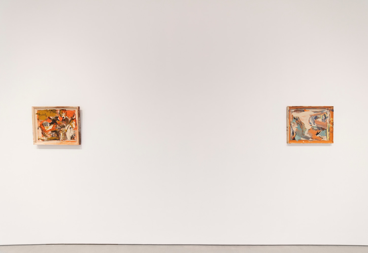 Two predominantly orange horizontal compositions at an intimate scale placed at a distance from each other on a white wall.