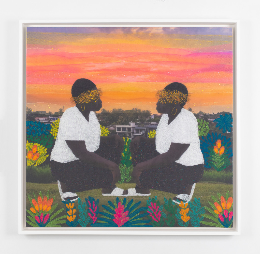 framed artwork of an embroidered digital photograph depicting to people crouching and facing towards each other on grass and in front of an orange pink sky