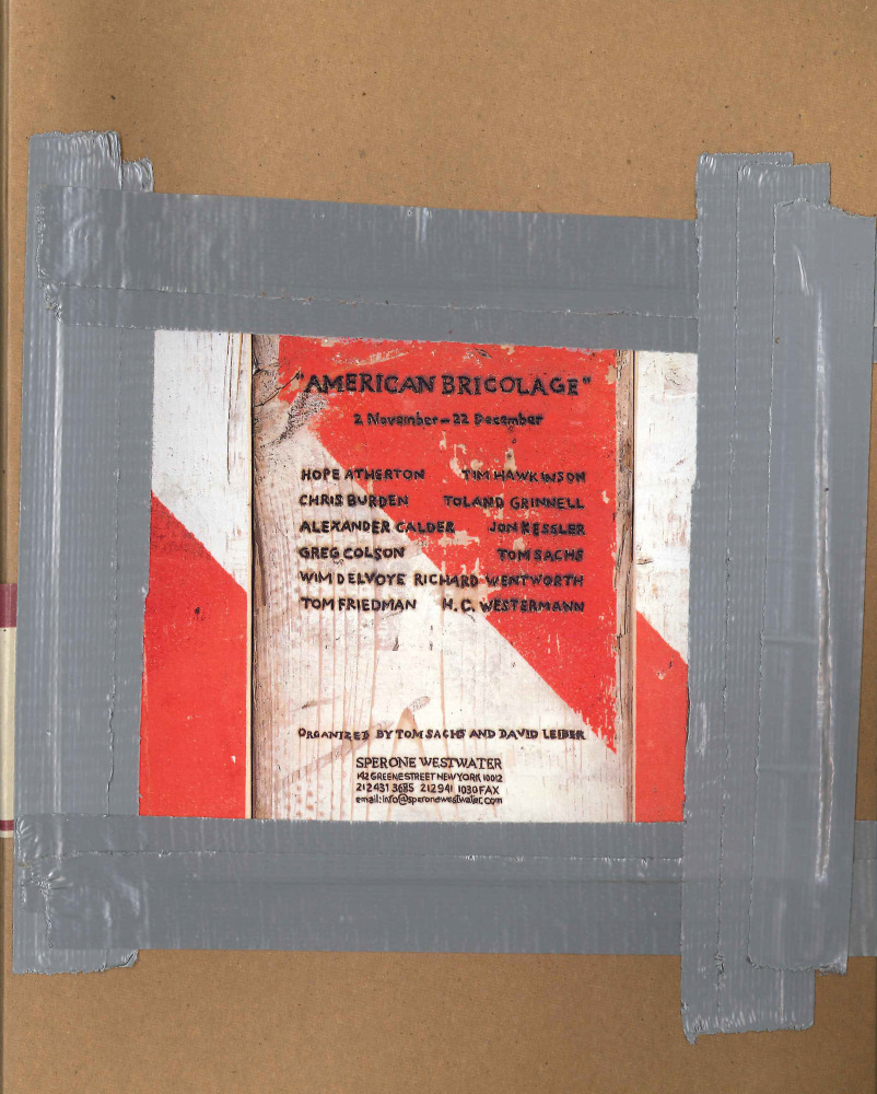 cardboard book cover with image containing exhibition details duct taped to the cover