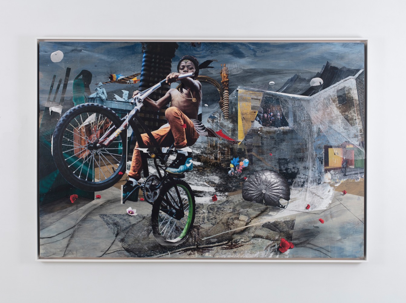 collaged painting of a boy popping a wheelie in the foreground of a city streetscape strewn with parachutes and poppies