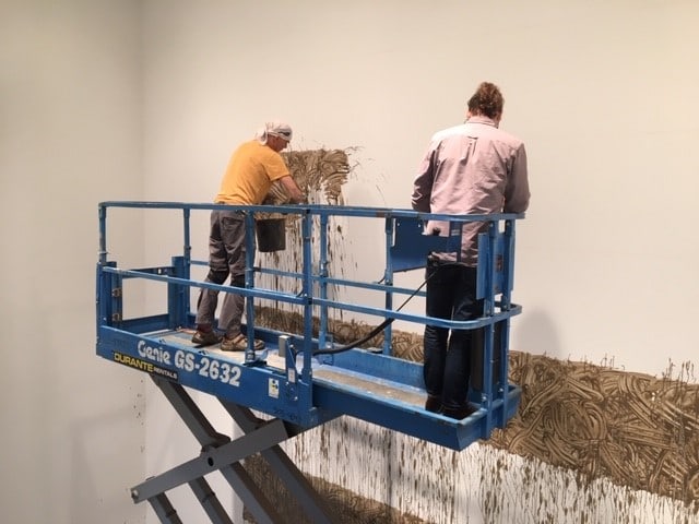 Richard Long installing Heaven, 2020, River avon mud, 345 3/16 x 450 3/16 inches.

Photograph &amp;copy; Denise Hooker, 2020.