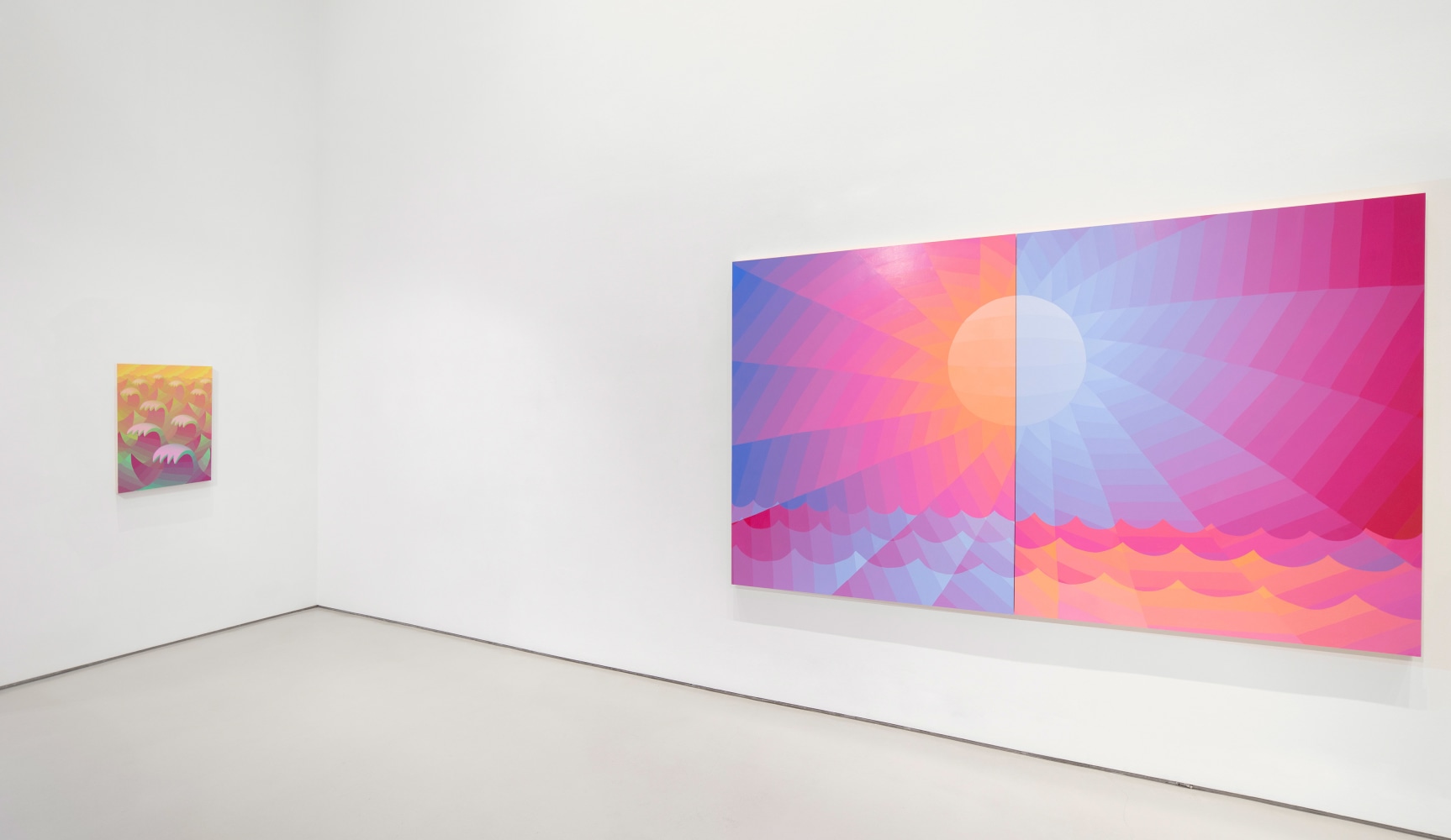 white walled gallery with large pink, orange, and blue diptych painting of a sun on the right and a smaller magenta and orange painting of waves of the left wall