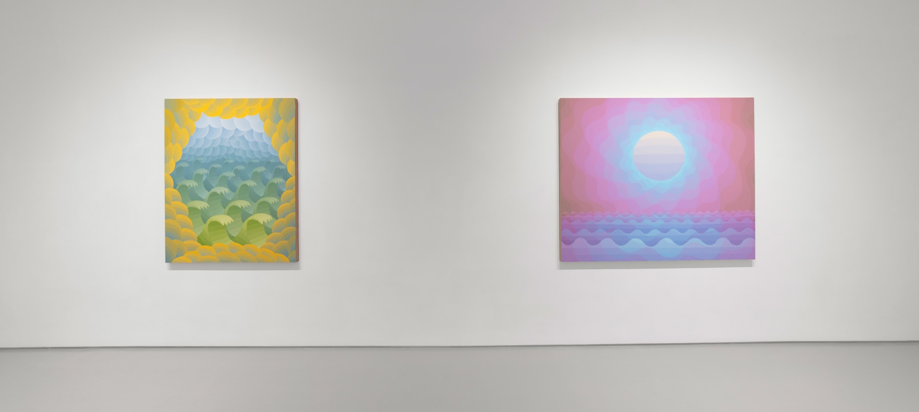 white walled gallery with two paintings: one pink, blue, and purple depicting a sun over water and the other yellow, blue, and green depicting clouds and waves