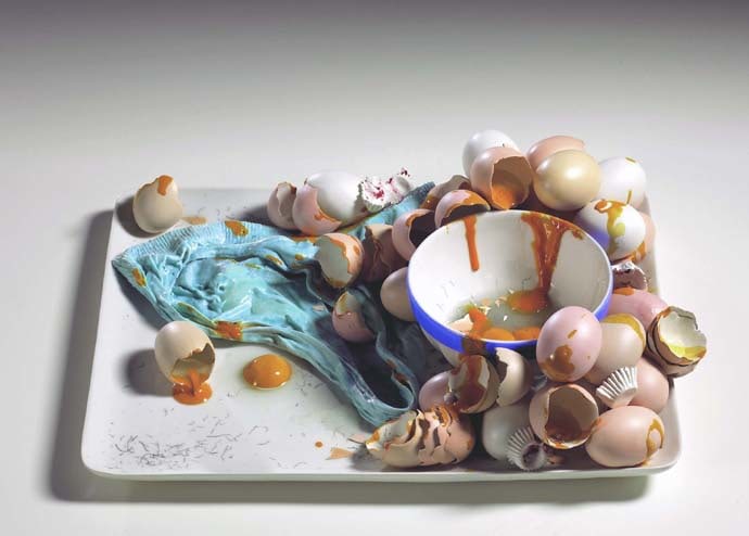 ceramic tray holding a bowl with broken eggs and eggshells