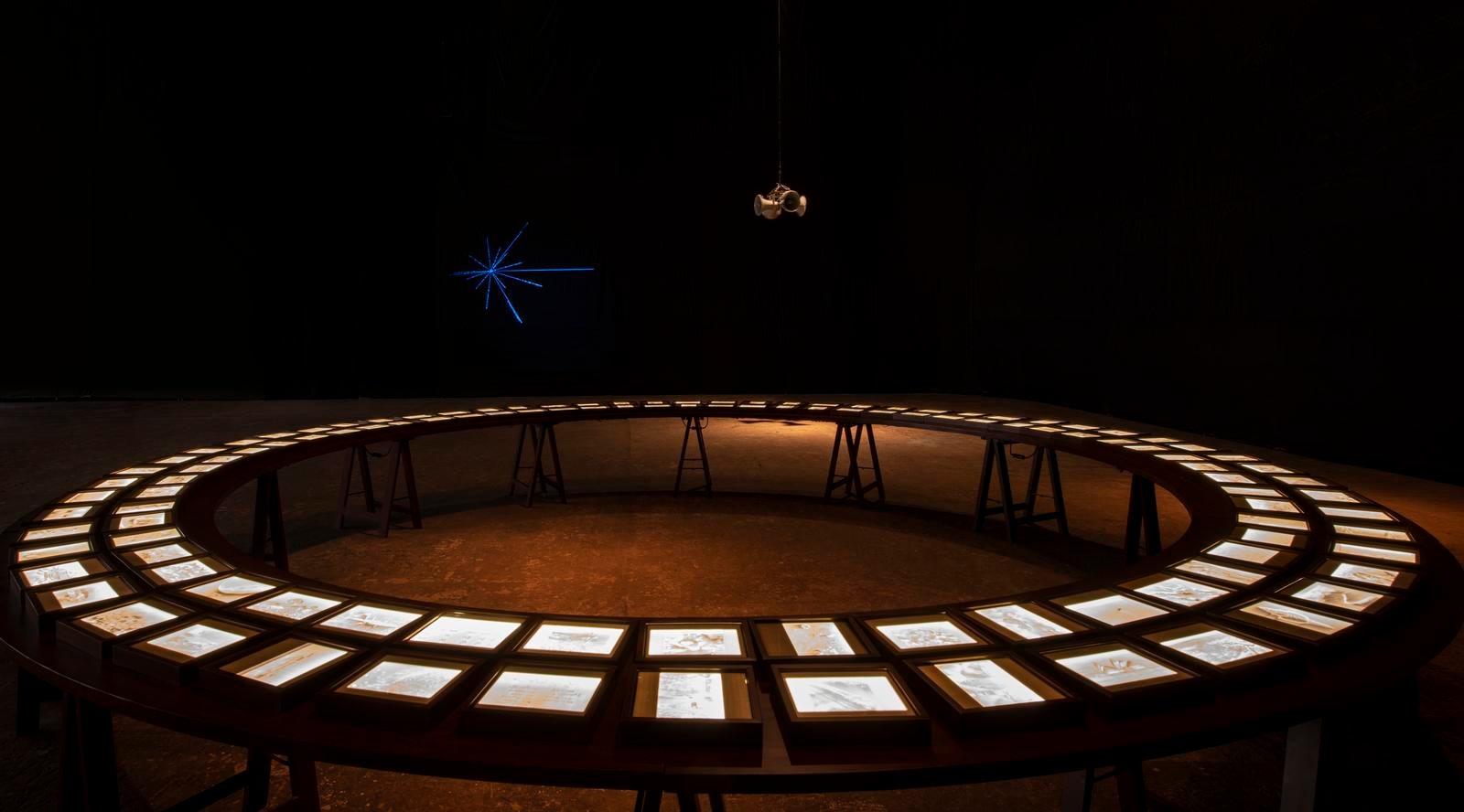 dark room with a circular table with papers organized neatly