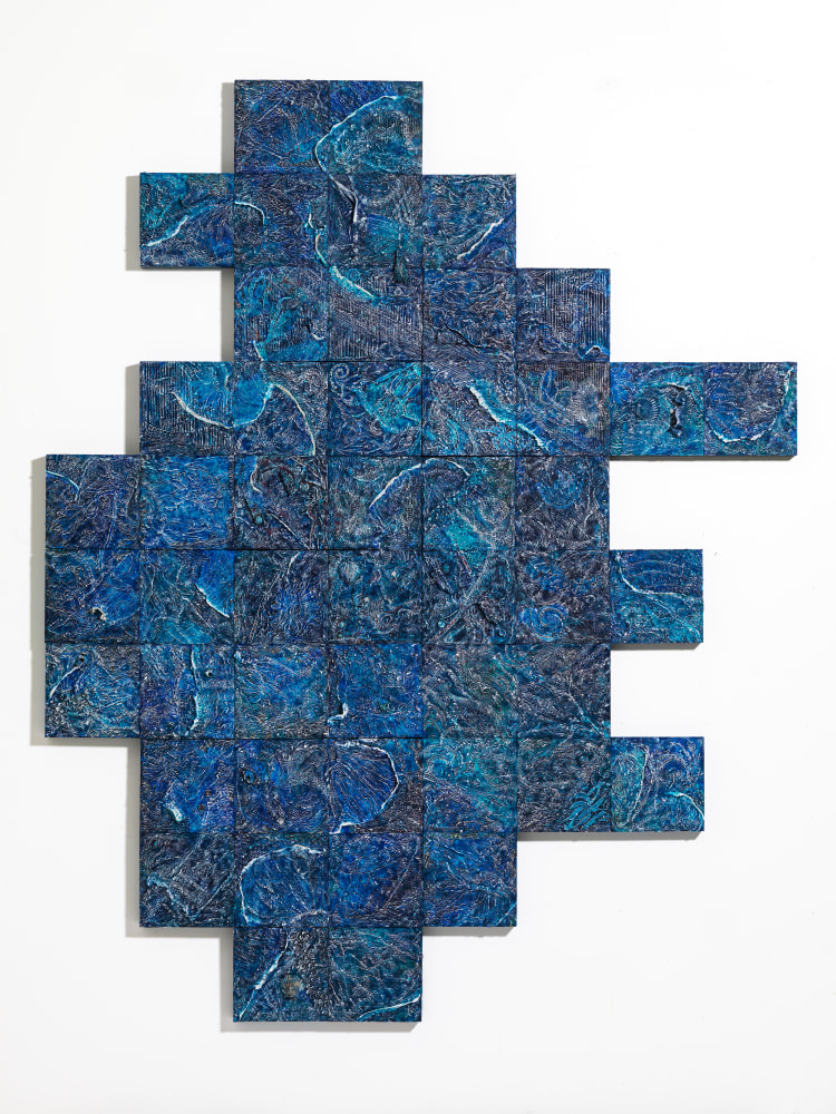A dense relief constructed with myriad materials and images across wood blocks in overall azure tones.