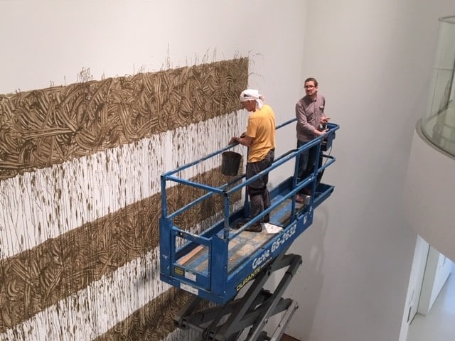 Richard Long installing Heaven, 2020, River avon mud, 345 3/16 x 450 3/16 inches.
Photograph &amp;copy; Denise Hooker, 2020.