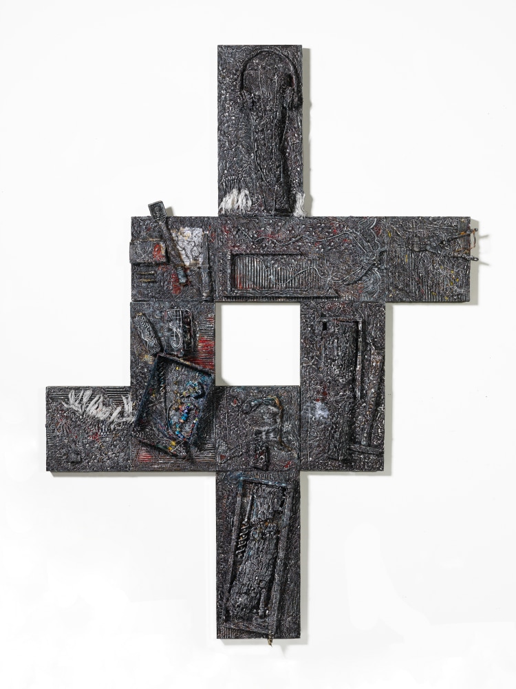 A relief built of ajoined reliefs branching out from a square, constructed with myriad materials and images across wood blocks in overall dark grey tones but accented with color..