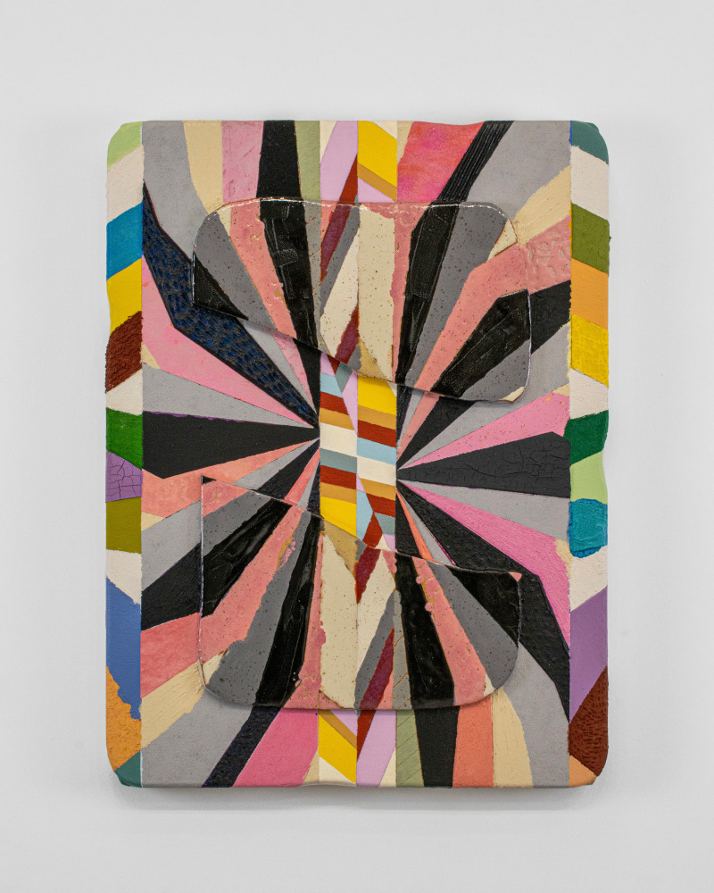 ceramic wall work with radiating stripes in pink, black, gray, yellow, green, orange, and other colors, forming a sunburst-like pattern. Two large curved tile fragments sit on top, partially obscuring the design and adding depth and shadow. The surface mixes glossy and matte textures, with visible cracks and speckles that enhance its tactile quality.