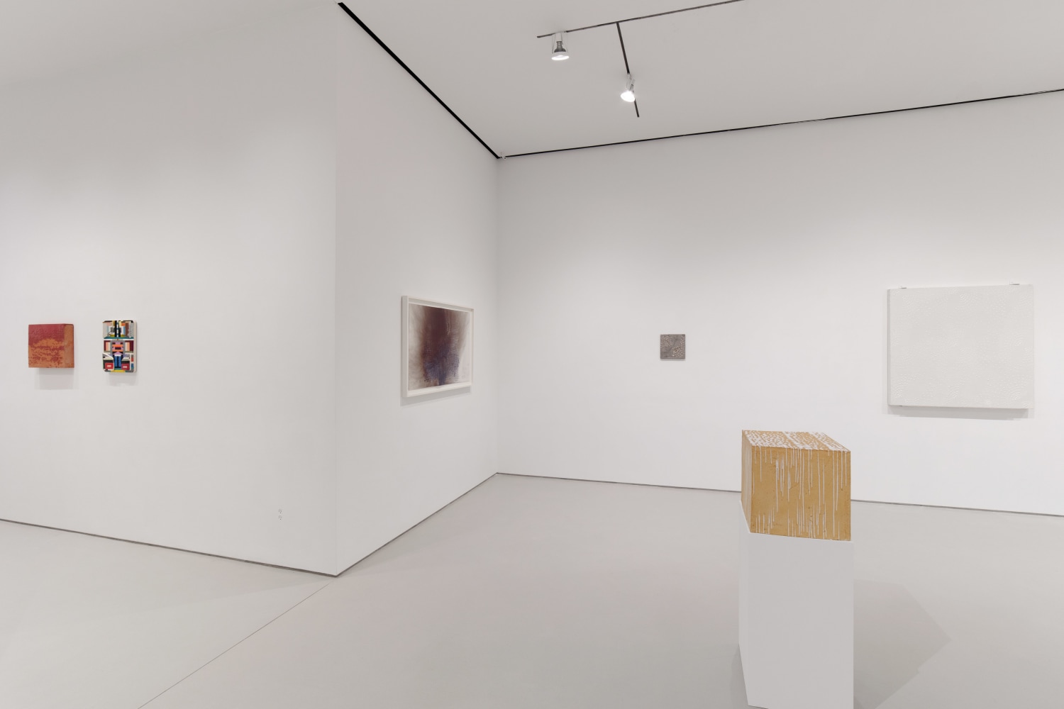 A view of the gallery with works by Otto Piene and Kevin Umaña on display.