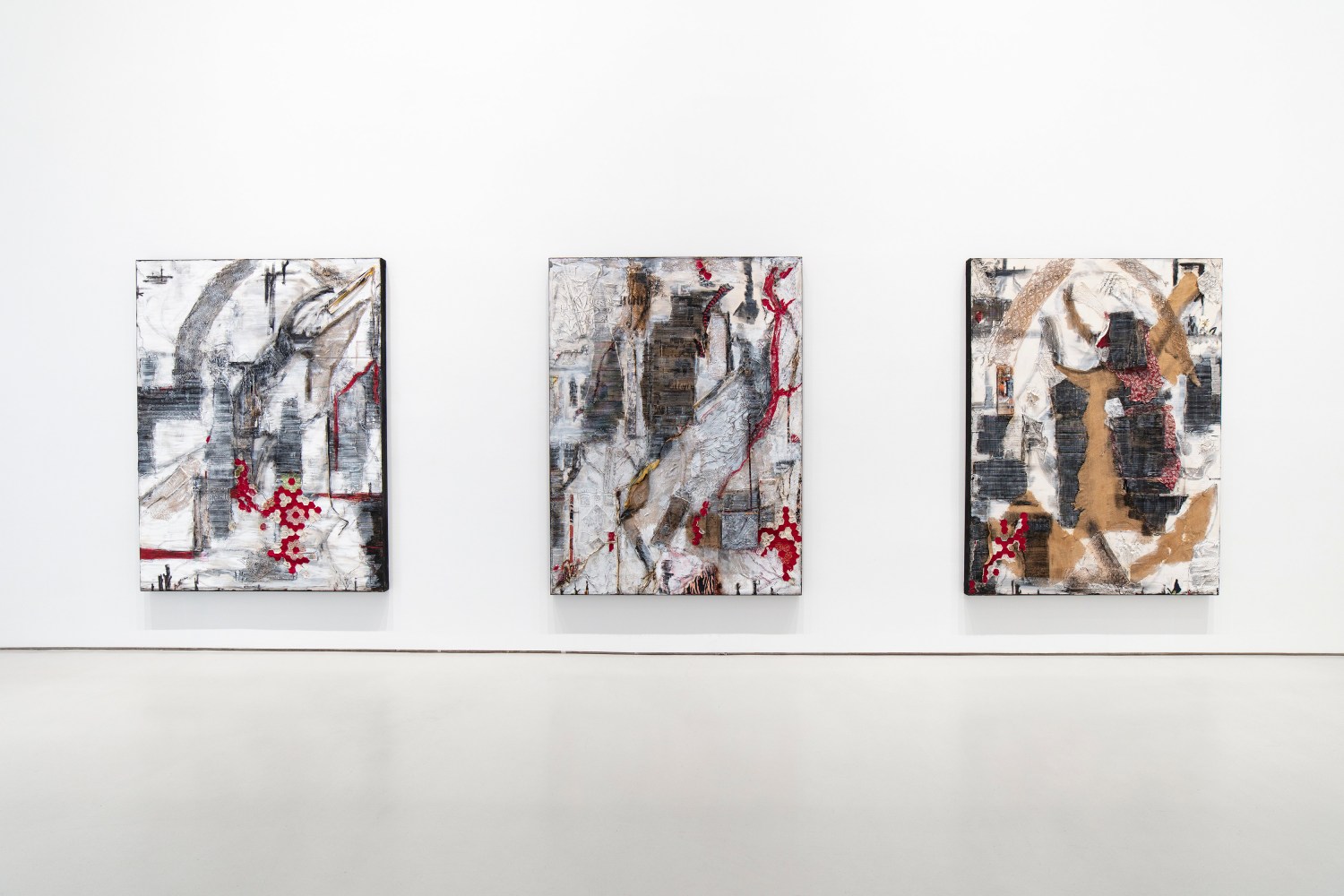 three 8 x 6 foot canvases hanging on white gallery wall. the artworks are made of white paint, red fabric, burlap, and cardboard, in abstract compositions