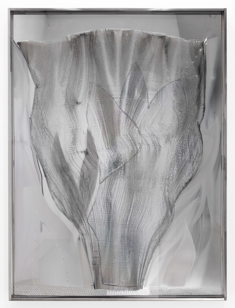 shiny aluminum relief sculpture of a fan or wing