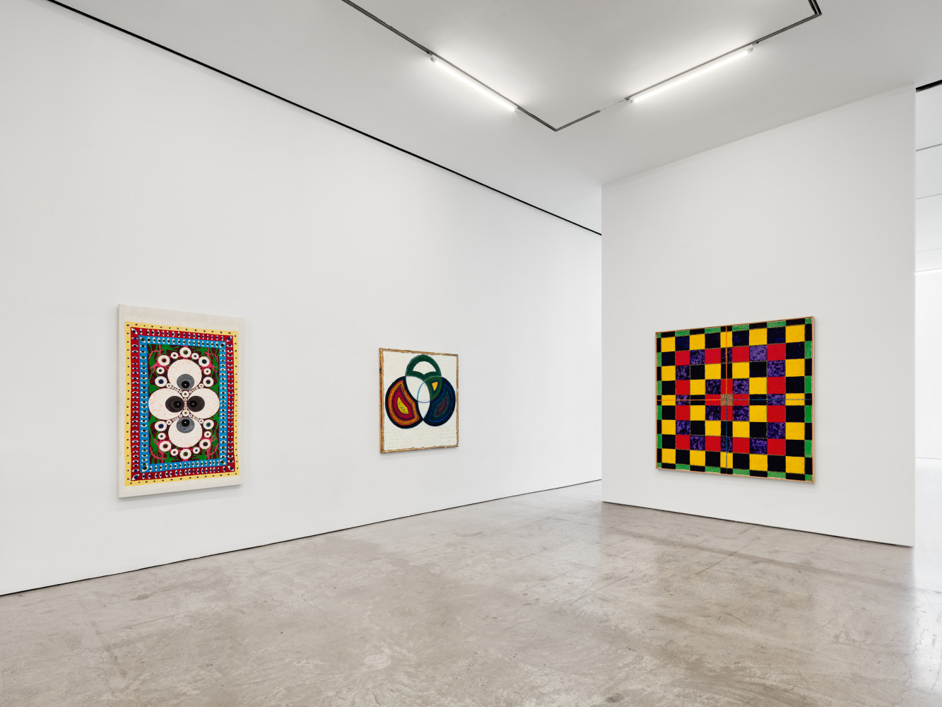 Installation view of &quot;Schema World as Diagram&quot; featuring three paintings in a white space.