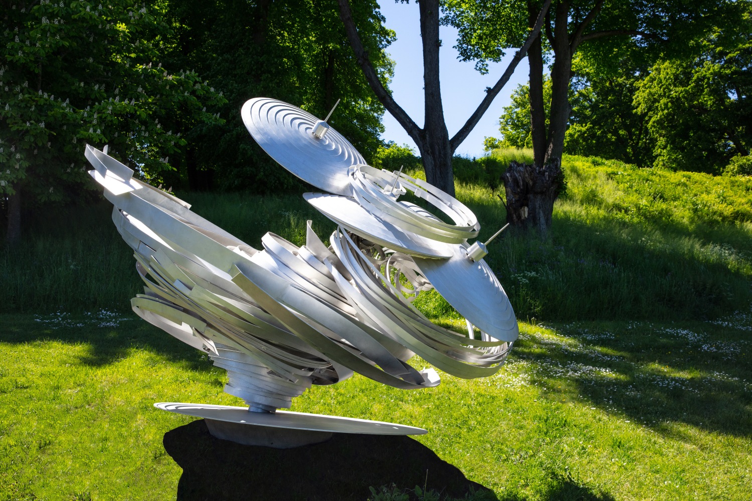 Outdoor installation view of large twisted aluminum sculpture by Alice Aycock