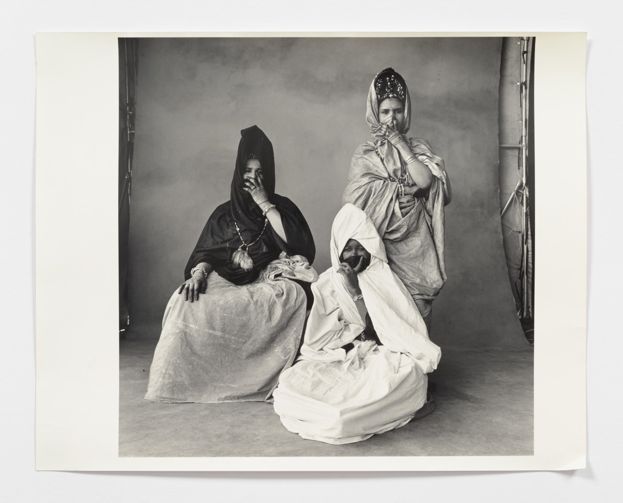 Black and white photograph of three women in drapery fabric.