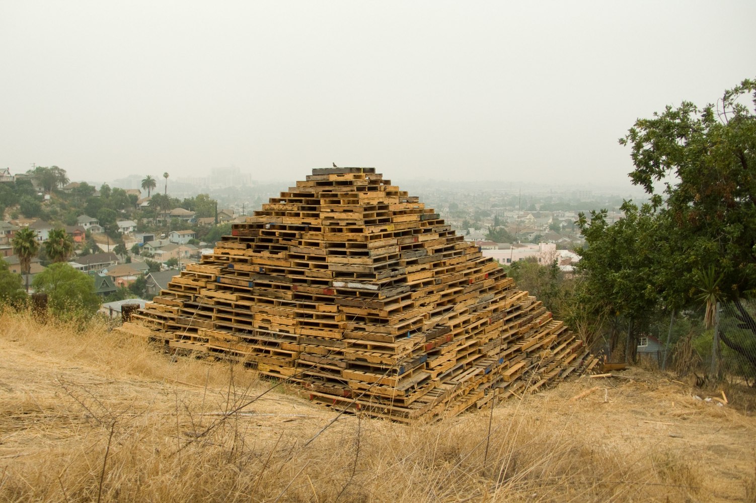 III, 2010, reclaimed wooden pallets, 16 x 27 x 27 feet
