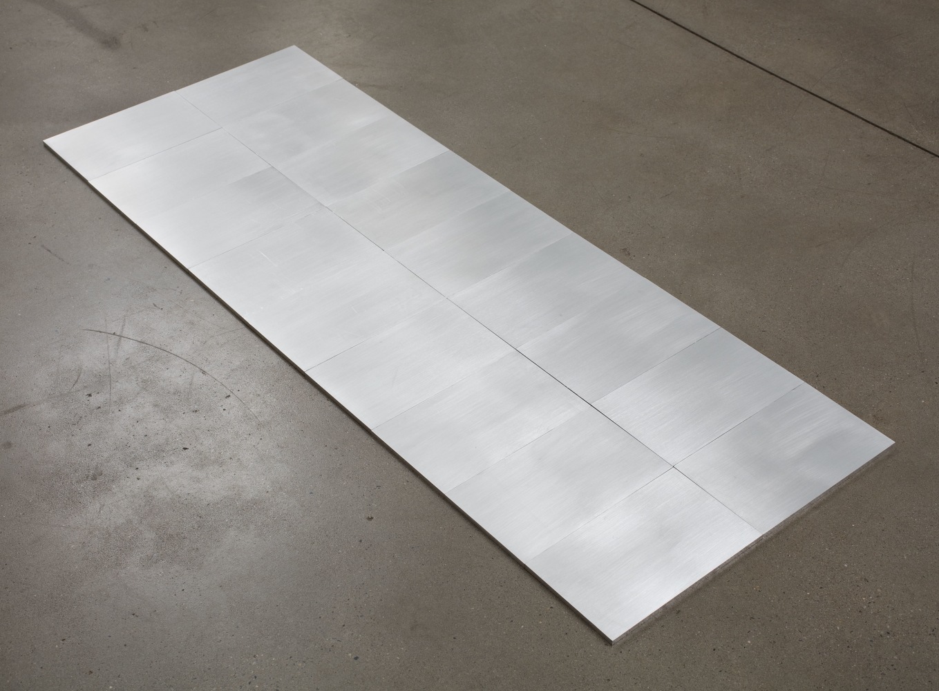 Carl Andre 18 Algon, 2000 aluminum: 18 unit rectangle (9 header x 2 stretcher)  each: 1/4 x 5 x 8 3/8  in. (.6 x 12.7 x 21.3 cm) overall: 1/4 x 16 5/8 x 45 in. (.6 x 42.2 x 114.3 cm)