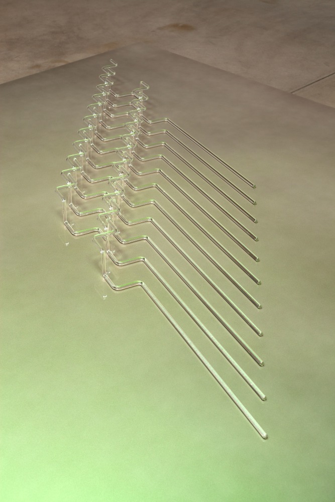 Tauba Auerbach A Flexible Fabric of Inflexible Parts, 2015 borosilicate glass on table of aluminum, wood and paint 11 helical components each approximately 3 x 3 x 31 1/2 inches (7.6 x 7.6 x 80 cm). Overall dimensions: 3 x 78 x 25 inches (7.6 x 198.1 x 63.5 cm) table: 23 1/2 x 84 x 84 in. (59.7 x 213.4 x 213.4 cm)