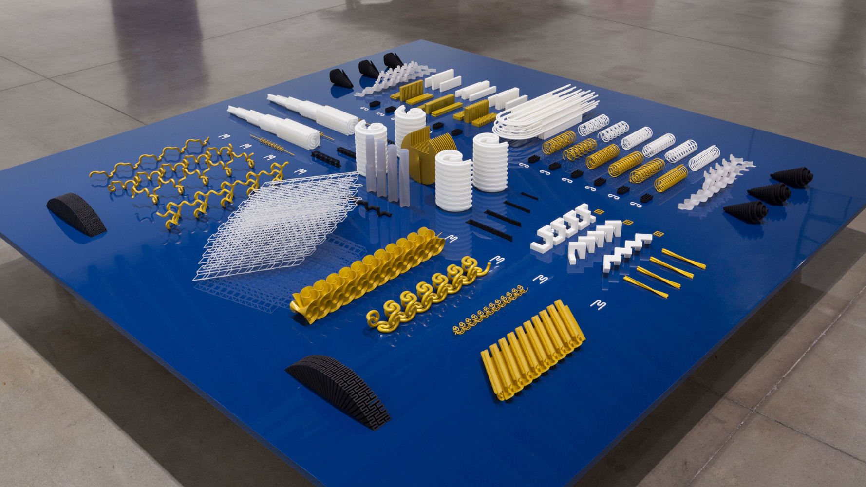 Altar/Engine, (detail), 2015 3D printed nylon and plastic on table of aluminum, wood and paint an array of 126 elements ranging from 18 x 18 x 10 in. (45.7 x 45.7x 25.4 cm) to .0625 x 1 x 2 in. (.16 x 2.5 x 5.1 cm) Table: 15 x 108 x 108 in. (38.1 x 274.3 x 274.3 cm)