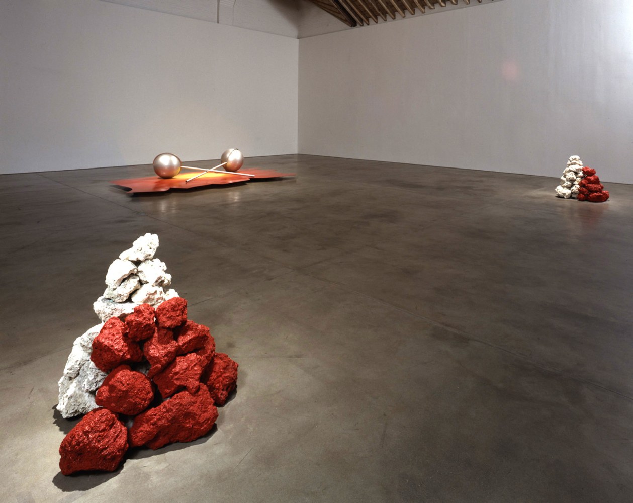 Robert Grosvenor
Untitled, 1999
fossil rock, sheet metal, plastic and acrylic enamel paint
rock pile left - 34 1/4 x 36 x 34 1/2” (85.6 x 90 x 86.2 cm), rock pile right - 34 1/4 x 35 1/2 x 36” (85.6 x 88.7 x 90 cm), platform - 5 3/4 x 176 x 89” (14.3 x 440 x 222.5 cm), two plastic elements - 24 1/2 x 24 1/2 x 93” (61.2 x 61.2 x 232.5 cm), each overall - 34 1/4 ” x 31’10” x 28’6” (85.6 cm x 9.5 m x 8.5 m)