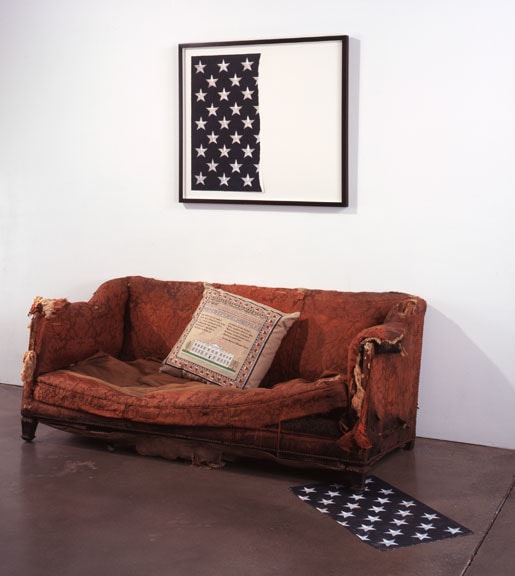 Hans Haacke "Mission Accomplished" 2005 Embosed vegetable dye digital capture on Somerset textural paper 29 7/8 x 18 1/4 in. "Trickle Up" 1992 Threadbare sofa; embroidered pillow 30 x 72 x 34 in.