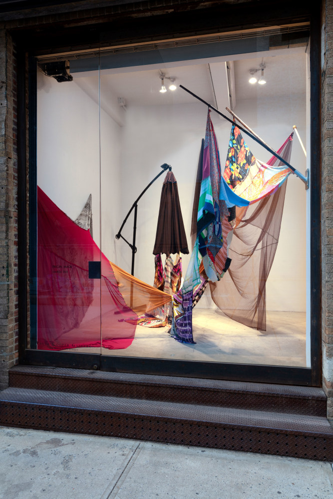 Eric N. Mack Landlord, 2021 umbrella, wood flagpoles, metal brackets, fabric collage, thread dimensions variable