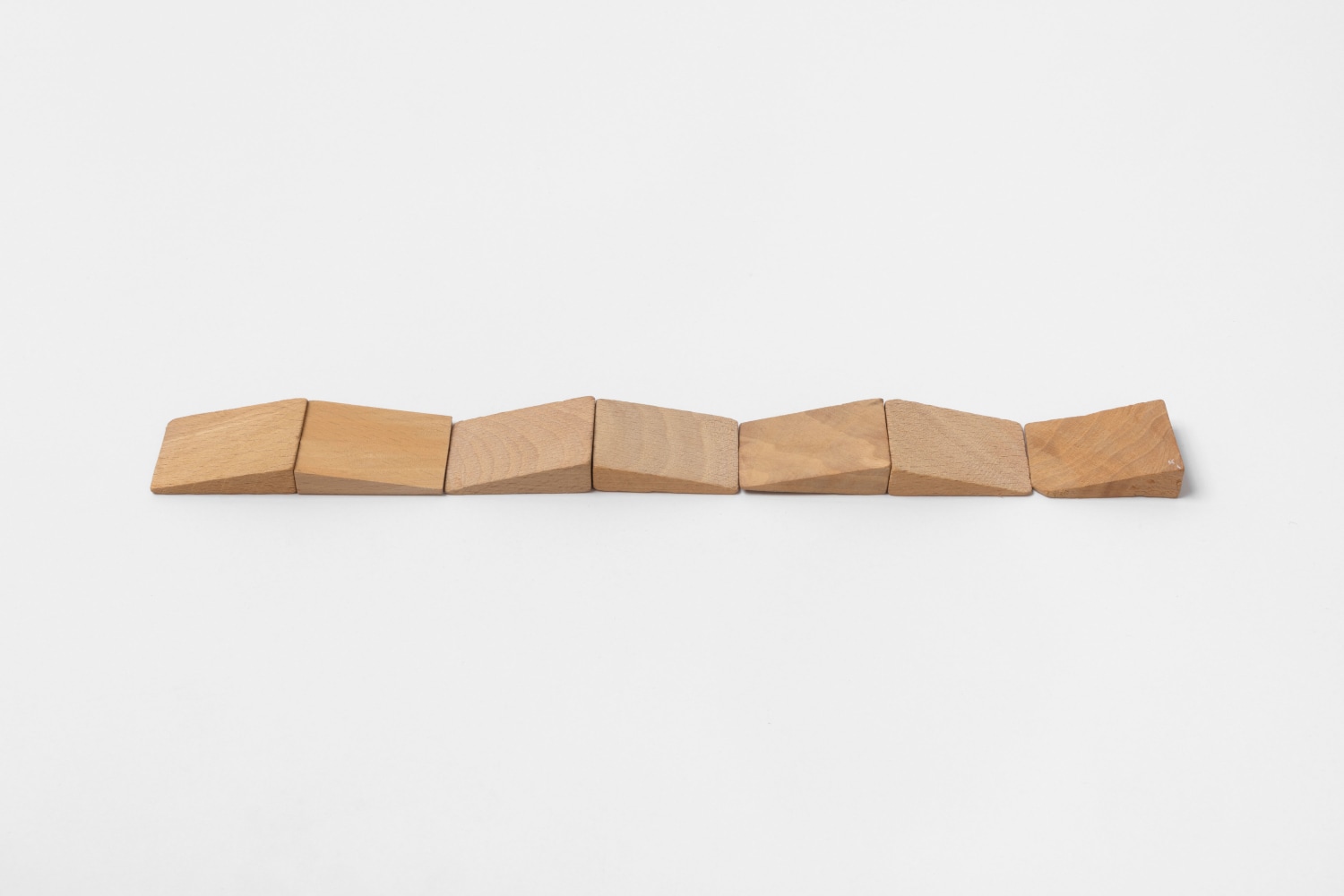 Carl Andre Septet Up and Down, 2015 wood triangles 7-unit row 3 sets of 2 units, on base with apexes touching, and 1 unit at end each: 3/8 x 1 1/8 x 1 5/8 in. (1 x 2.9 x 4.1 cm) overall: 3/8 x 1 1/8 x 11 1/8 in. (1 x 2.9 x 28.3 cm)