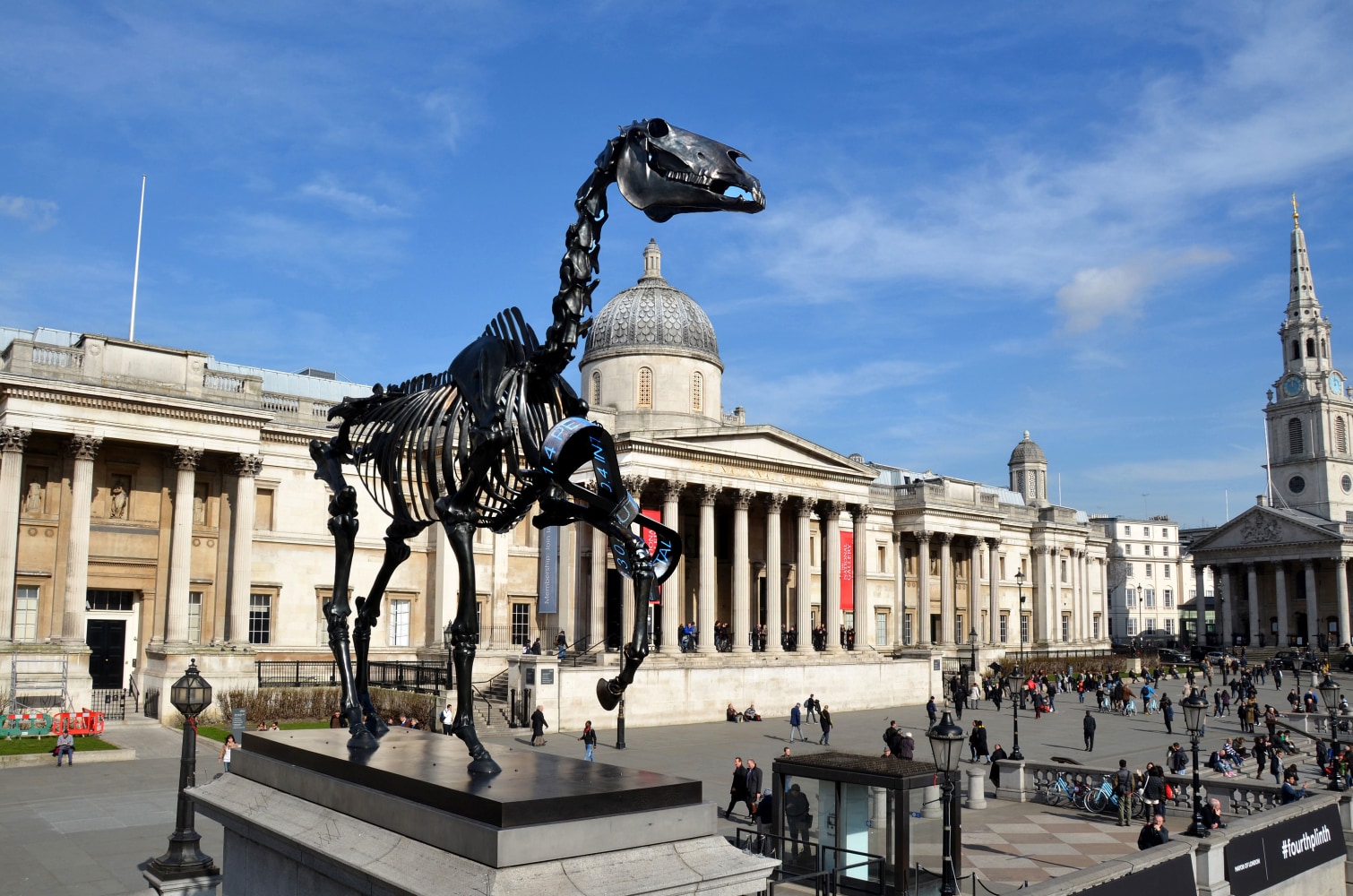 Hans Haacke Gift Horse, 2014 horse: bronze with black patina and wax finish stainless steel fasteners and supports, bow: 5mm flexible LED display stainless steel armature polycarbonate face, 15 ft 3 in. x 14 ft 1 in. x 5 ft 5 in. (464.8 x 429.3 x 165.1 cm). Commissioned by the Mayor of London's Fourth Plinth Programme.
