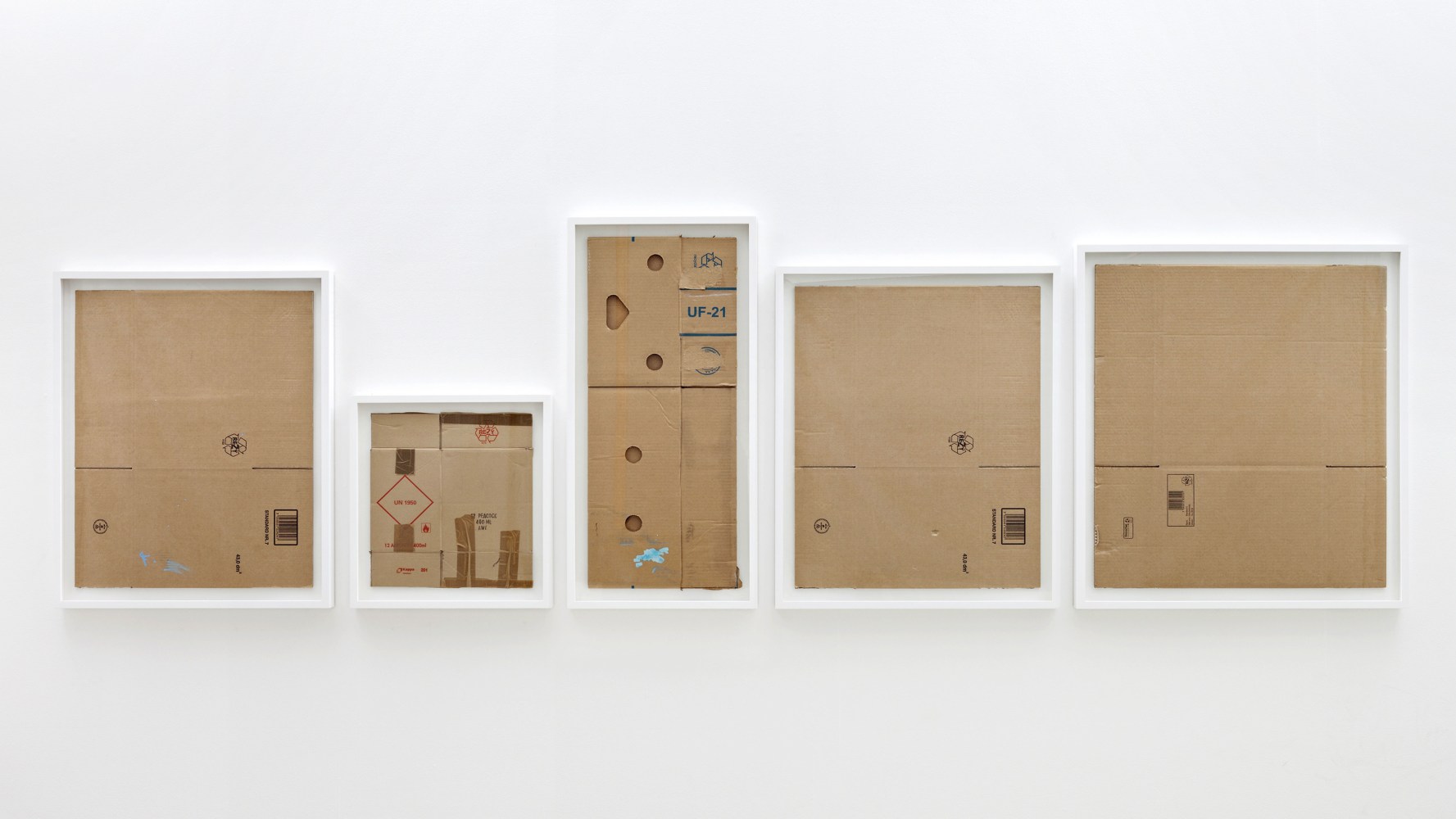 Matias Faldbakken Five Flat Boxes, 2013 5 cardboard boxes, ink, tape, wooden frames Panel A: 33 3/4 x 27 3/4 in. (85.7 x 70.5 cm) Panel B: 21 x 20 in. (53.3 x 50.8 cm) Panel C: 38 3/4 x 18 1/2 in. (98.4 x 47 cm)  Panel D: 33 3/4 x 27 3/4 in. (85.7 x 70.5 cm) Panel E: 35 1/2 x 31 3/4 in. (90.5 x 80.5 cm) Overall: 38 3/4 x 138 in. (98.4 x 350.5 cm)