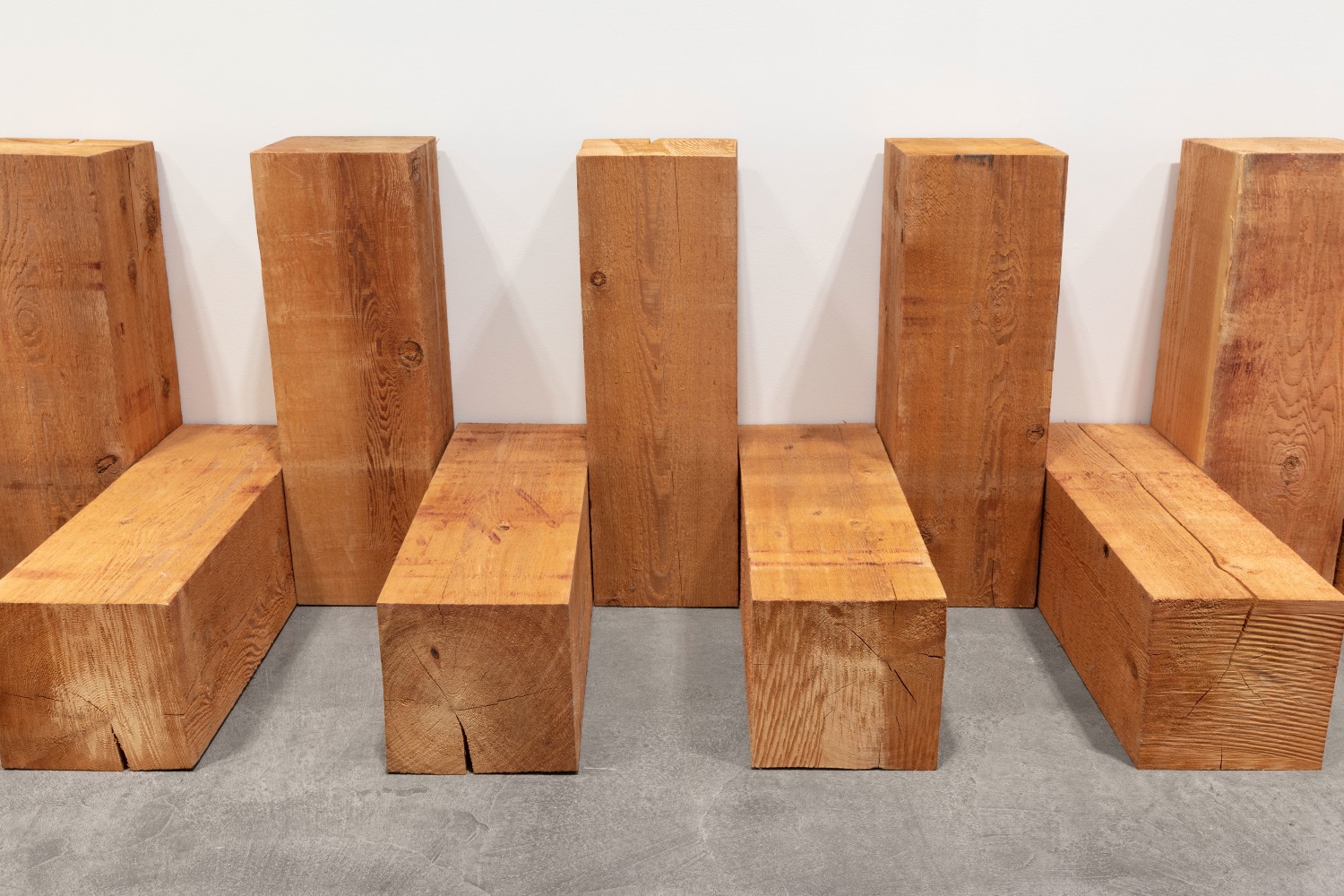 Carl Andre
Diarch, 1979
Western Red Cedar 60-unit array on floor, along two opposing walls; two rows of 30
alternating horizontal and vertical units
each: 12 x 12 x 36 inches (30.5 x 30.5 x 91.4 cm); 
overall: 36 x variable x 360 inches (91.4 x variable x 914.4 cm)