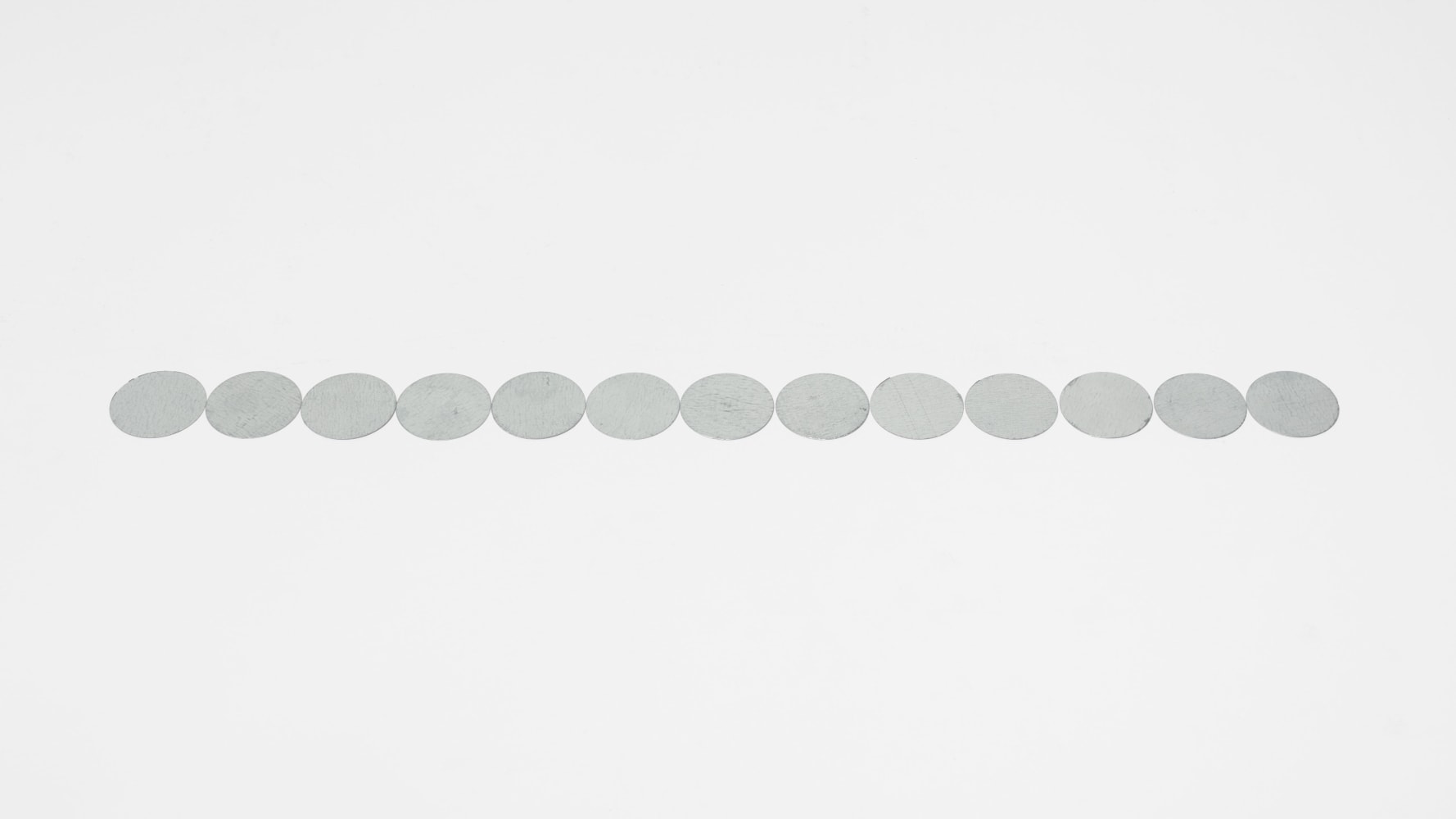 Carl Andre 13 Part Galvanized Steel Disc Row, 2016 galvanized steel 13 elements, each: 1/32 x 1 5/8 in. (.1 x 4.1 cm) overall: 1/32 x 1 5/8 x 21 1/4 in. (.1 x 4.1 x 54 cm)