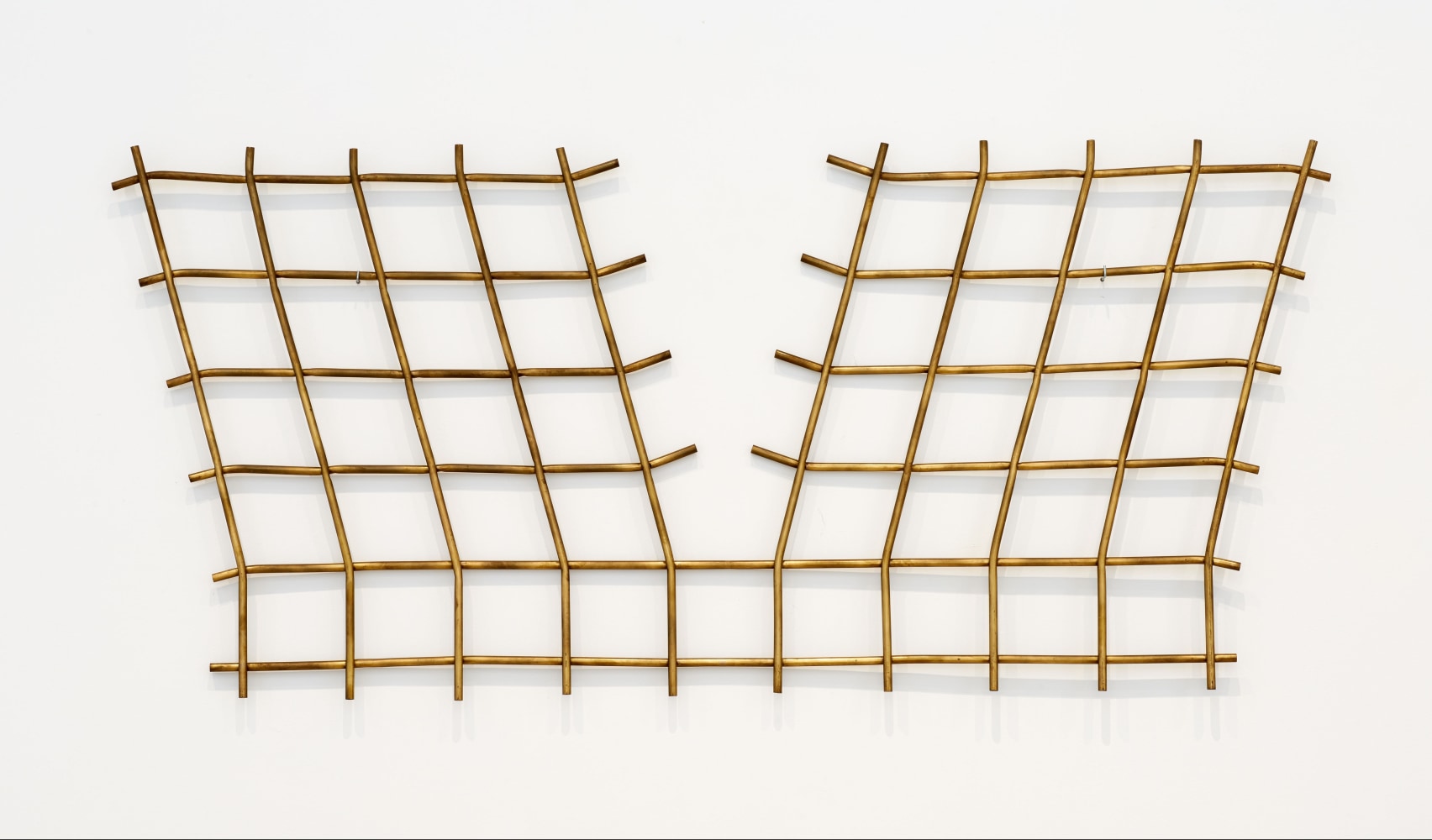 Luciano Fabro Struttura ortogonale assoggettata ai quattro vertici a tensione, 1964 brass tubing 41 x 89 3/8 in. (104 x 227 cm)