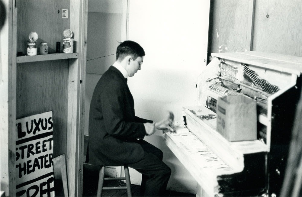 Peter Moore "George Maciunas performing his 'Piano Piece No. 13' Fluxhall, 359 Canal Street, NY" May 9, 1964 gelatin silver print 8 x 10 in.