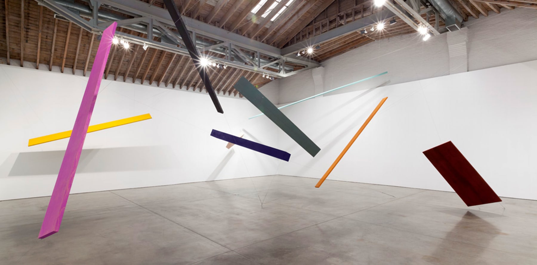 Joel Shapiro Untitled, 2012-2014 wood, casein, and cord 10 pieces: A: 1 9/16 x 10 x 170 in. (4.0 x 25.4 x 431.8 cm) (orange/brown) B: 1 3/16 x 13 1/2 x 142 1/2 in. (3.0 x 34.3 x 362.0 cm) (green/grey) C: 10 1/2 x 16 x 131 in. (26.7 x 40.6 x 332.7) (paris blue) D: 8 x 17 1/2 x 80 in. (20.3 x 44.5 x 203.2 cm) (pink) E: 1 5/16 x 20 x 174 in. (3.3 x 50.8 x 442.0 cm) (yellow) F: 1 3/4 x 6 x 211 7/8 in. (4.4 x 15.2 x 538.2 cm) (lamp black) G: 1 27/32 x 13 x 151 in. (4.7 x 33.0 x 383.5 cm) (cobalt violet) H: 2 x 4 x 320 in. (5.0 X 10.2 X 812.8) (malachite) I: 1 11/16 x 3 x 240 in. (4.3 X 7.6 X 609.6 cm) (white) Door: 1 1/8 x 39 7/8 x 86 in. (2.9 x 101.3 x 218.4 cm) (urbino red) installation dimensions variable