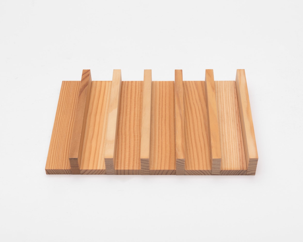Carl Andre 12 Wood Side/Edge Row, 2016 wood 12 elements, each: 1/4 x 4 1/8 x 1 in. (.6 x 10.5 x 2.5 cm) overall: 7/8 x 4 1/8 x 7 7/8 in. (2.2 x 10.5 x 20 cm)
