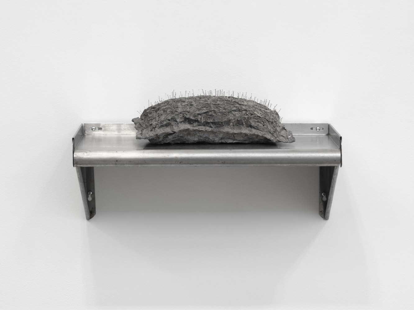 Veronica Ryan Pin Cushion, 1986 lead foil, cushion, pins, ink cushion: 5 1/2 x 14 1/2 x 8 1/8 in. (14 x 36.8 x 20.6 cm) shelf: 9 3/4 x 24 1/4 x 11 1/2 in. (24.8 x 61.6 x 29.2 cm)