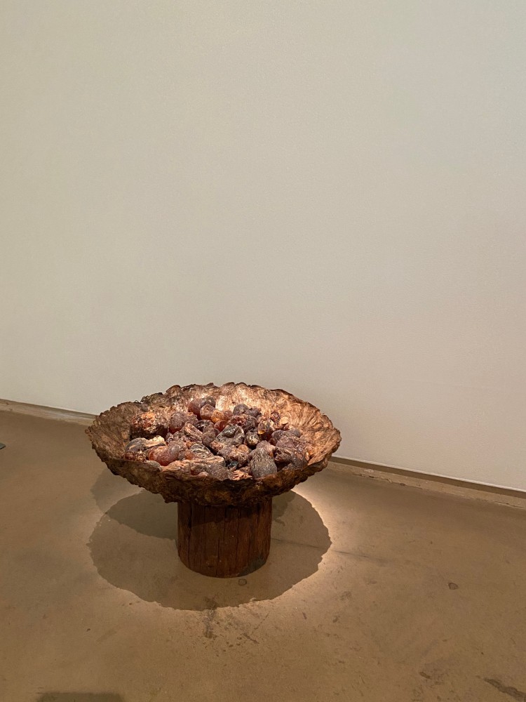 BENITHA PERCIYAL, Blind Perfume of the Earth, 2021, tree gum on Banana fibre and Rosewood, circular objects placed inside a banana fibre bowl, rosewood base