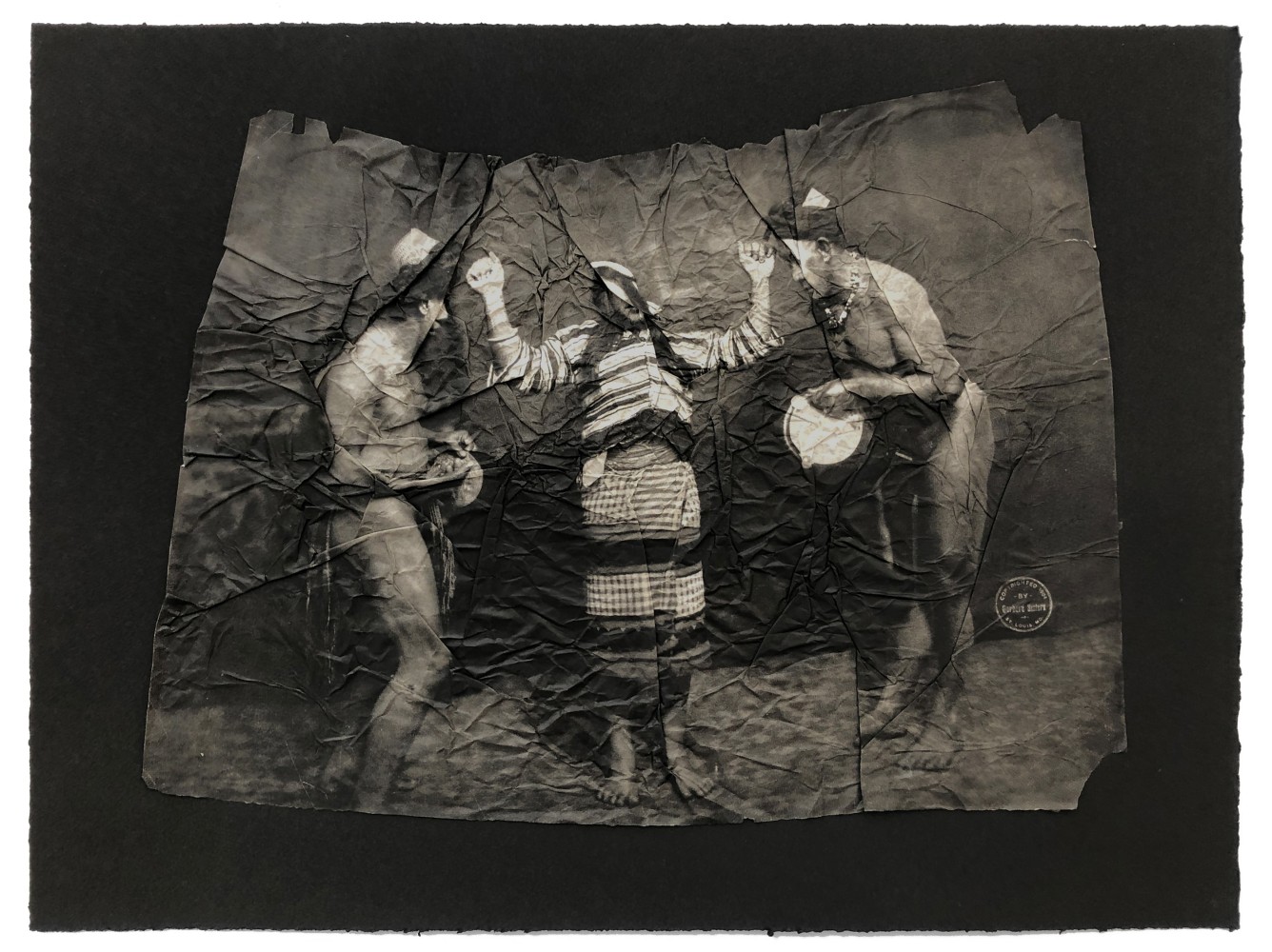Afterimages (Interference of Vision)
Stephanie Syjuco, 2021

Photogravure printed on gampi mounted on Somerset black 280 gram cotton rag;
Re-edited photograph of an ethnological display of Filipinos from the 1904 St. Louis World&amp;rsquo;s Fair
Image: 16&amp;quot; x 20&amp;quot; ; Sheet: 18&amp;quot; x 24&amp;quot;
Crumpled/folded gampi is proud by 1/8&amp;rdquo; from back mounted layer
Edition of 20 plus 8 proofs
$4500

Printed by Paul Mullowney and Harry Schneider, Co-published by BOXBLUR, Catharine Clark Gallery, and Mullowney Printing, San Francisco, CA and Portland

PURCHASE